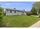 One story home featuring a vibrant green lawn, mature trees, and well-maintained landscaping at 3058 W 134Th Way, Broomfield, CO 80020