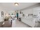Open concept kitchen featuring sleek countertops, white cabinetry, and an airy connection to the living room at 3058 W 134Th Way, Broomfield, CO 80020