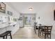 Bright kitchen area with modern appliances, a breakfast bar, and a dining area next to a sliding glass door at 3058 W 134Th Way, Broomfield, CO 80020