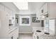 Bright kitchen featuring white cabinetry, black hardware, granite countertops, and modern appliances at 3058 W 134Th Way, Broomfield, CO 80020