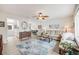 Open concept living room with a ceiling fan, comfortable seating, and view into the dining area and kitchen at 3058 W 134Th Way, Broomfield, CO 80020