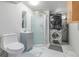 Basement bathroom with shower stall, newer washer and dryer, and gray cabinets at 305 Titan St, Aurora, CO 80011