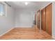 Bright bedroom with hardwood floors, ceiling fan, closet, and view to the ensuite bathroom at 305 Titan St, Aurora, CO 80011