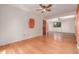 Bright bedroom featuring hardwood floors, a ceiling fan, and two windows at 305 Titan St, Aurora, CO 80011