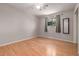 Cozy bedroom featuring hardwood floors, a ceiling fan, and a window with backyard views at 305 Titan St, Aurora, CO 80011