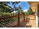 Exterior deck featuring wood flooring and wooden railings surrounded by green trees at 305 Titan St, Aurora, CO 80011