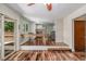 Open-concept dining space with hardwood flooring, a view into the kitchen, and a sliding door to the patio at 305 Titan St, Aurora, CO 80011