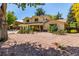 Charming home featuring unique architectural design, and mature landscaping, all under a clear blue sky at 305 Titan St, Aurora, CO 80011