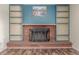 Charming brick fireplace with built-in shelves, adding character to the room with stylish accents at 305 Titan St, Aurora, CO 80011