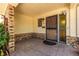 A welcoming front porch with brick accents and a sturdy, secure metal front door at 305 Titan St, Aurora, CO 80011