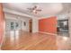 Open concept living room featuring hardwood floors, ceiling fans, and a full bathroom at 305 Titan St, Aurora, CO 80011