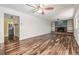 Bright living space with hardwood floors, fireplace, and a glimpse of the adjacent updated bathroom at 305 Titan St, Aurora, CO 80011