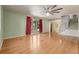 Bright living room with hardwood floors, a ceiling fan, and abundant natural light at 305 Titan St, Aurora, CO 80011