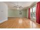 Spacious living room showcasing beautiful hardwood floors and a large window with natural light at 305 Titan St, Aurora, CO 80011