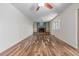 Spacious living room featuring hardwood floors, a brick fireplace, and built-in shelves for storage and decor at 305 Titan St, Aurora, CO 80011