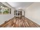 Bright, open living space with hardwood floors, a view into the kitchen, and access to the backyard patio at 305 Titan St, Aurora, CO 80011