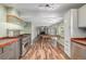 Open living space boasts a chef's kitchen, dining area, and a cozy fireplace, perfect for modern living at 305 Titan St, Aurora, CO 80011