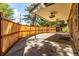 View of a covered outdoor patio with decorative fence and ceiling fans for comfortable outdoor living at 305 Titan St, Aurora, CO 80011