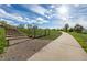 A paved walking path and staircase leading to a fenced-in grassy area at 305 Titan St, Aurora, CO 80011