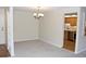 Spacious dining room features neutral carpet, chandelier, and is adjacent to the kitchen at 14390 E Marina Dr # 104, Aurora, CO 80014