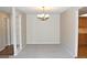 Spacious dining room features neutral carpet, chandelier, and is adjacent to the kitchen at 14390 E Marina Dr # 104, Aurora, CO 80014