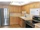 Updated kitchen featuring stainless steel appliances, and light wood cabinetry at 14390 E Marina Dr # 104, Aurora, CO 80014
