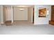 Open-concept living and dining area with neutral carpet, breakfast bar, and adjacent kitchen view at 14390 E Marina Dr # 104, Aurora, CO 80014