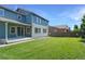 A well-maintained, grassy backyard featuring a patio and a two-story home with blue siding at 15378 W 50Th Pl, Golden, CO 80403