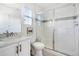 Bright bathroom features a glass enclosed shower, toilet and vanity with marble countertop at 15378 W 50Th Pl, Golden, CO 80403