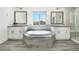 Beautiful bathroom features a large soaking tub with a window, double sinks and a glass shower at 15378 W 50Th Pl, Golden, CO 80403