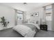 Cozy bedroom features a plush bed, neutral decor and gray curtains at 15378 W 50Th Pl, Golden, CO 80403