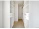 White walk-in closet with built-in shelving and drawers on both sides at 15378 W 50Th Pl, Golden, CO 80403