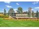 Beautiful community entrance sign with lush landscaping and well-kept lawn at 15378 W 50Th Pl, Golden, CO 80403