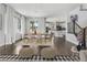 Open-concept dining area and kitchen featuring hardwood floors, modern decor, and ample natural light at 15378 W 50Th Pl, Golden, CO 80403