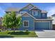 Charming two-story home with blue siding, a well-manicured lawn, and a two-car garage at 15378 W 50Th Pl, Golden, CO 80403