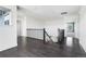 Well-lit hallway featuring wood floors and decorative wrought-iron railing at 15378 W 50Th Pl, Golden, CO 80403