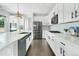 Bright kitchen with white cabinets, stainless steel appliances, modern subway tiles, and a gas range at 15378 W 50Th Pl, Golden, CO 80403
