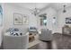 Cozy seating area featuring modern decor, comfortable chairs, and a stylish rug on hardwood floors at 15378 W 50Th Pl, Golden, CO 80403