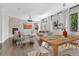 Bright living room and dining area with hardwood floors, a fireplace, and large windows at 15378 W 50Th Pl, Golden, CO 80403