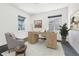 Bright home office with hardwood flooring, a large desk, a comfortable chair, and natural light from two windows at 15378 W 50Th Pl, Golden, CO 80403