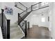 Elegant staircase featuring dark wood railings, carpeted steps, and a well-lit entry area at 15378 W 50Th Pl, Golden, CO 80403