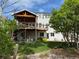 Expansive backyard featuring a wooden deck, patio area, lush lawn and mature trees creating a private outdoor retreat at 2369 Bayberry Ln, Castle Rock, CO 80104