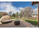 Private backyard with a cozy lounge area, fire pit, and lush green landscaping at 2369 Bayberry Ln, Castle Rock, CO 80104