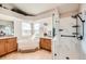 Bright bathroom featuring a soaking tub, double sink vanity, and walk-in shower with marble tile at 2369 Bayberry Ln, Castle Rock, CO 80104