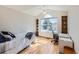Well-lit bedroom with large window, built-in shelves, and light hardwood floors at 2369 Bayberry Ln, Castle Rock, CO 80104