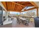 Inviting covered deck with ample seating, dining space, and string lights for outdoor enjoyment at 2369 Bayberry Ln, Castle Rock, CO 80104