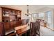 Inviting dining room with a large wooden table, built-in hutch, and natural light from windows at 2369 Bayberry Ln, Castle Rock, CO 80104