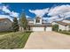 Charming two-story home with a three-car garage and well-manicured lawn on a sunny day at 2369 Bayberry Ln, Castle Rock, CO 80104