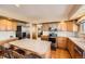 Modern kitchen featuring wood cabinets, stainless steel appliances, and an island with barstool seating at 2369 Bayberry Ln, Castle Rock, CO 80104