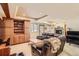 Comfortable living room with a stone fireplace, a built-in wooden bookcase, and plush leather seating at 2369 Bayberry Ln, Castle Rock, CO 80104